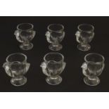 A set of 6 moulded glass egg cups of pedestal form with chicken decoration. 2 3/4" high Please
