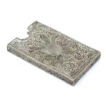 A white metal card vase with filigree decoration . 3" long Please Note - we do not make reference to
