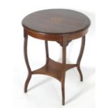 An early 20thC occasional table with a circular top decorated with a marquetry inlaid cornucopia,