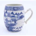 A Chinese blue and white export mug of barrel form decorated with an Oriental landscape with