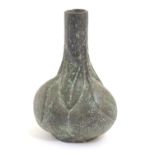 An Oriental pottery bottle vase with a faux bronze finish, the bulbous body modelled as stylised