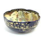 A Japanese export bowl with a lobed rim, decorated with Geisha girls with fans and flowers in a