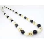 A vintage necklace of graduated beads approx 36" long Please Note - we do not make reference to
