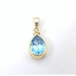 A 9ct gold pendant set with blue topaz 1/2" long Please Note - we do not make reference to the