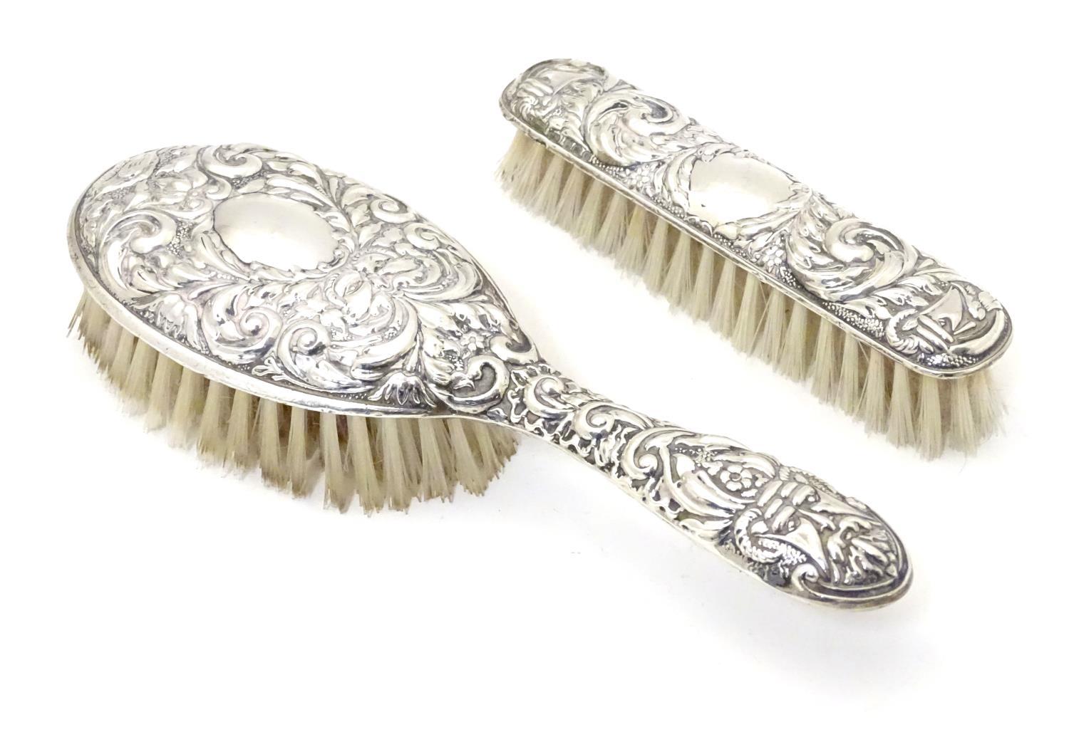 A silver handled brush together with a silver backed brush both with embossed decoration. Hallmarked - Image 2 of 5