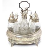 A George III cruet set, the stand with engraved decoration, containing 8 cut class bottles with