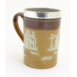 A Royal Doulton salt glaze two tone tankard with a silver rim hallmarked Sheffield 1909, maker Lee &