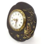 An unusual clock / timepiece, the enamelled dial and movement set within a Tsuba from a Japanese
