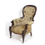 A mid / late 19thC spoon back armchair with a moulded surround and a deep buttoned leather backrest,