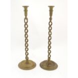 A pair of early 20thC brass candlesticks with open twist columns. Approx. 20 1/4" high (2) Please