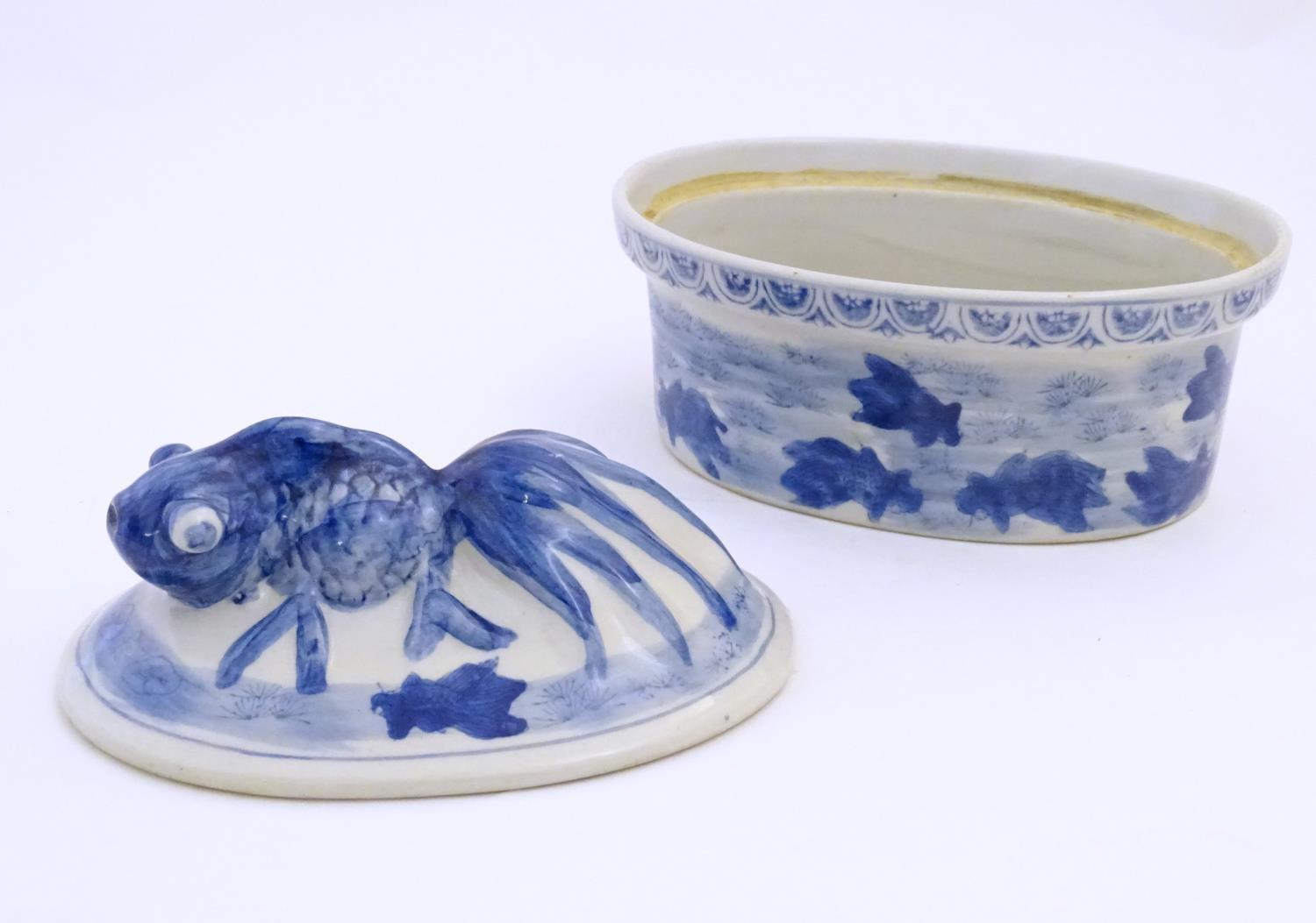 A Chinese blue and white dish and cover of oval form, the lid surmounted by a fish in relief, the - Image 6 of 6