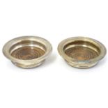 A pair of silver plate small coasters with turned wooden bases 4 1/4" diameter (2) Please Note -