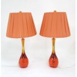 A pair of Retro table lamps with orange resin bases chrome fittings and resin / celluloid screw