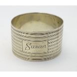 An Art Deco silver napkin ring with banded decoration. Hallmarked London 1945 maker GFB Please
