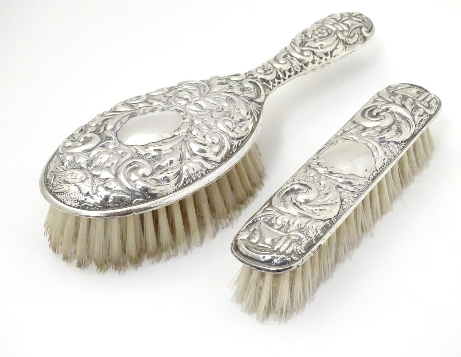 A silver handled brush together with a silver backed brush both with embossed decoration. Hallmarked - Image 3 of 5