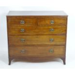 An early 19thC mahogany chest of drawers with a rectangular top above two short over three drawers