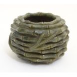 An Oriental carved jade / hardstone pot of circular form with carved bamboo detail. Approx. 2 3/4"