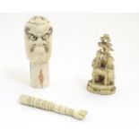 Two Japanese 19thC bone carvings comprising a hand seal with carved masks / faces to the top,