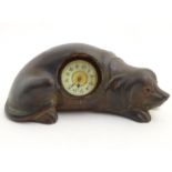 A late 19thC / early 20thC novelty mantle clock, the clock / timepiece set within a carved wooden