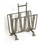 An early 20thC wrought iron magazine rack with a twist handle. 16 1/2" wide x 9" deep x 21" high.