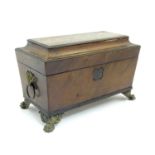 A 19thC mahogany tea caddy of sarcophagus form with brass cornucopia ring handles, and lion paw
