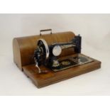 An early 20th Frister & Rossman vibrating shuttle sewing machine, in a walnut case, approximately