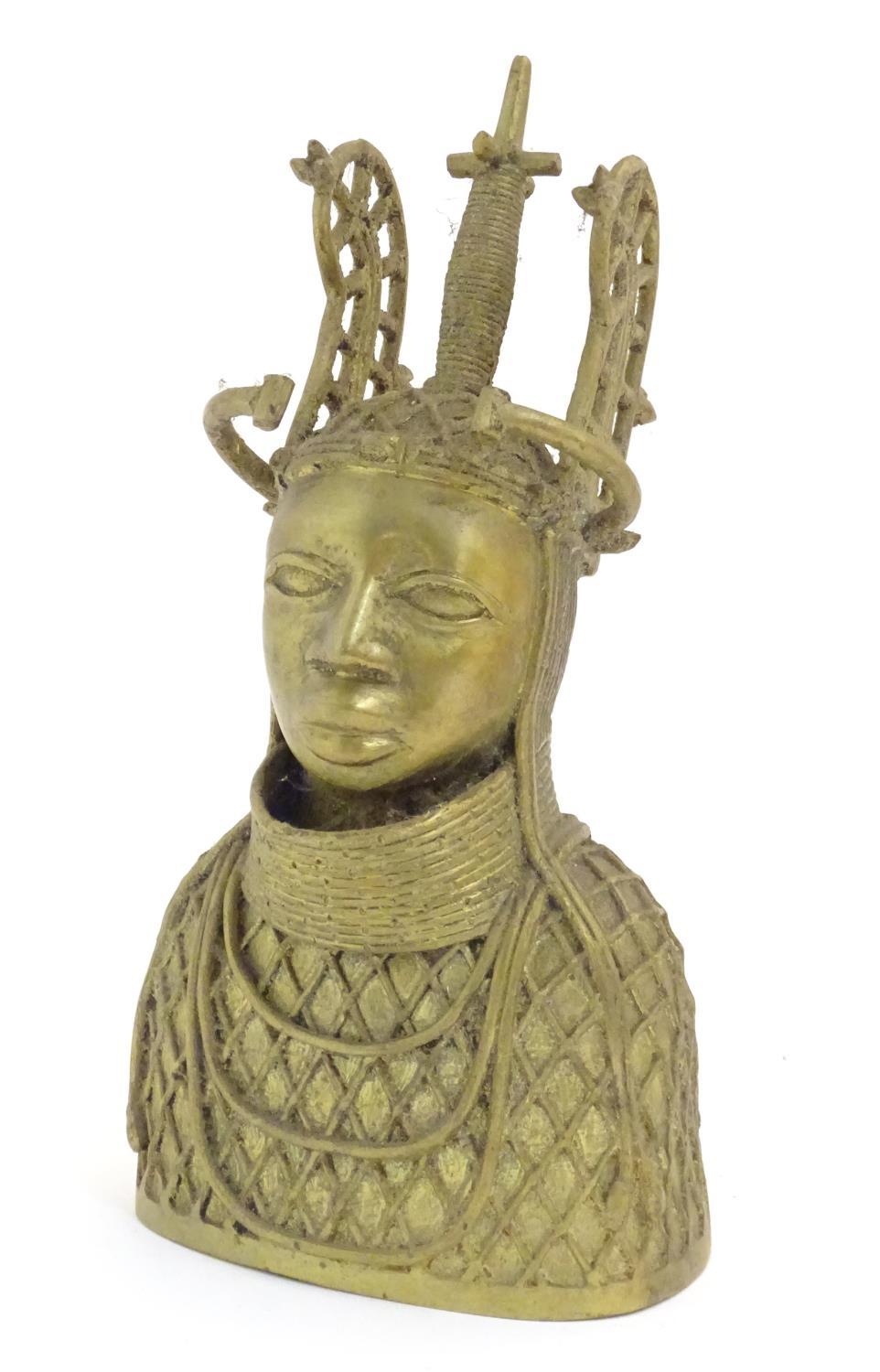 An early 20thC cast model of the Benin Bronze bust depicting Oba of Benin in ceremonial dress.