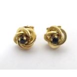 A pair of 9ct gold stud earrings set with blue stones 1/ 4" wide Please Note - we do not make