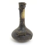 A Continental ceramic amphibian bottle vase, the body decorated with a frog and crocodile in relief,