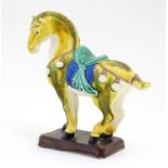 A Chinese model of a Tang style horse. Approx. 5 3/4" Please Note - we do not make reference to