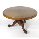 A mid 19thC walnut breakfast / dining table with a large moulded top above a carved base and three