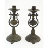 A pair of late 19thC cast gimbal mounted candlesticks with foliate decoration, with bracket to