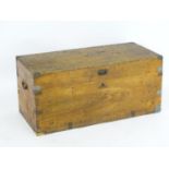 A 19thC teak and camphor wood trunk, bound with brass brackets and having wrought iron carrying