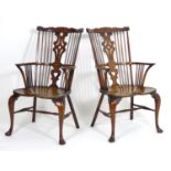 A pair of 20thC elm and yew Windsor armchairs, having comb backs and pierced central splats above