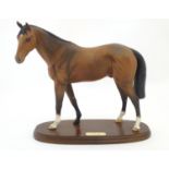 A Royal Doulton matte equestrian model of the horse Troy on an oval base. Marked under and titled to