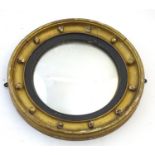A 19thC gilt wood convex mirror with ebonised banding and applied bauble decoration. 17 1/2"