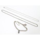 Two silver chain necklaces together with a silver chain bracelet with two charms, one formed as a