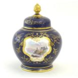 A Coalport pot pourri with a cobalt blue ground with gilt detail and a central hand painted