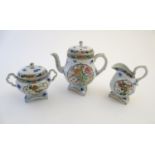 A Japanese teapot, twin handled sugar bowl and milk jug decorated with hand painted insects and