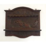 A 20thC carved pipe rack for wall mounting, depicting a man in a landscape, titled Solace For All