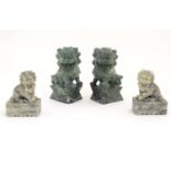 A pair of Oriental carved soapstone foo dogs. Together with another smaller pair. The larger pair