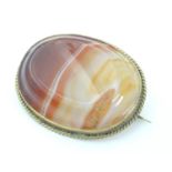 A late 19thC / early 20thC brooch set with agate hardstone in a gilt metal mount. 1 3/4" wide Please