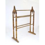 An early 20thC towel rail with a ring turned frame and five hanging bars. 33" high x 26" long.