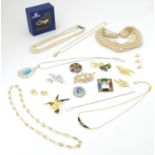 Assorted costume jewellery including various necklaces brooches etc and a Swarovski bow formed