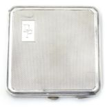 An Art Deco silver compact with engine turned decoration. Hallmarked Birmingham 1947maker Joseph
