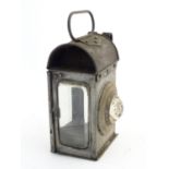 An early 20thC left hand side carriage lamp with bullseye glass, two bevel glass lenses and