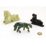 An Oriental jade/ hardstone model of a horse, together with two soapstone examples. Largest