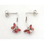 9ct white gold drop earrings with butterfly detail red stones. 3/4" long Please Note - we do not