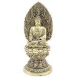 An Oriental brass model of seated Buddha on a stylised lotus flower pedestal throne, the mandorla