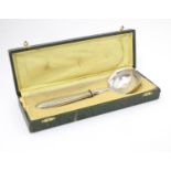 An Art Deco Continental white metal handled serving ladle. Cased. Approx 9" long Please Note - we do